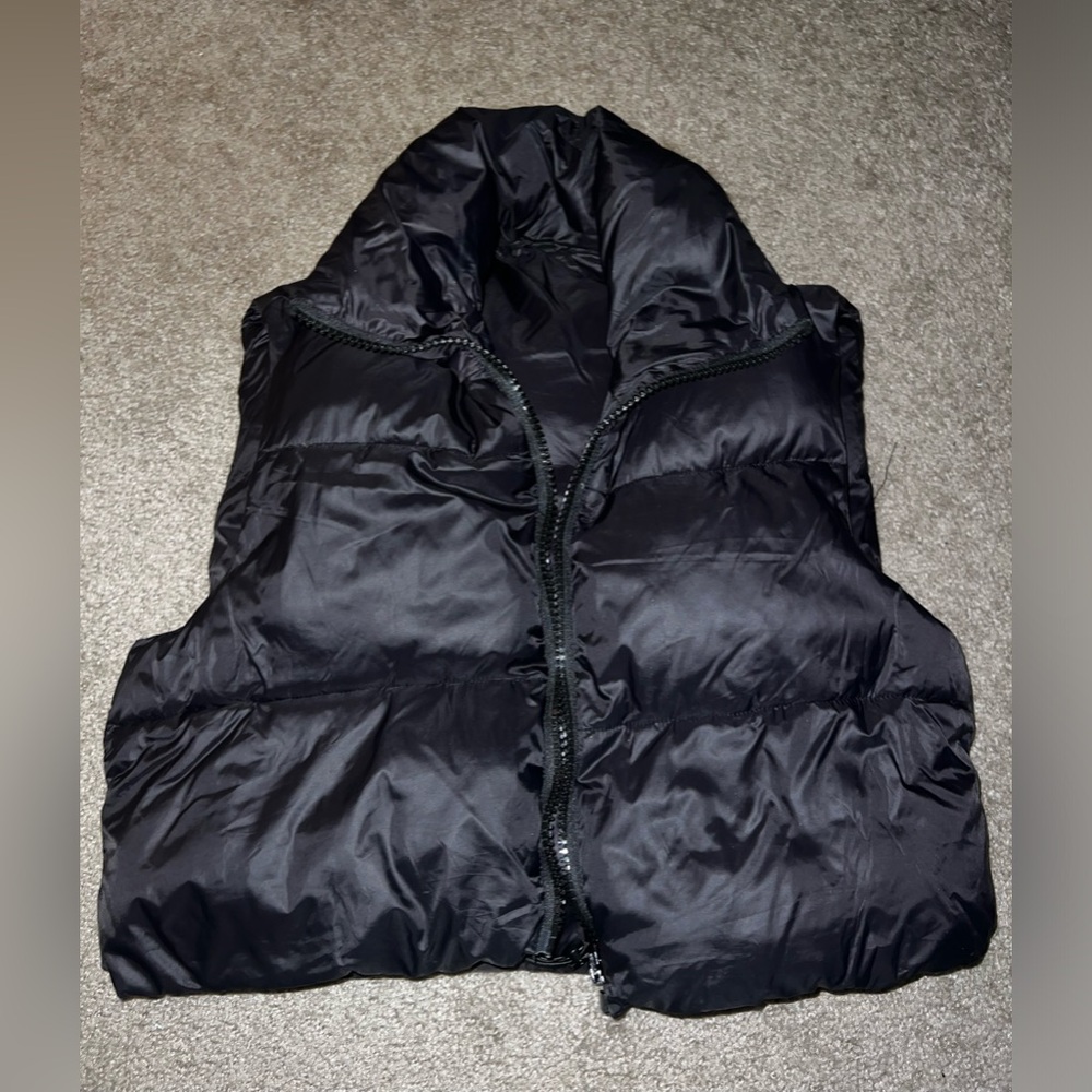 Puffer vest with drawstring waist.